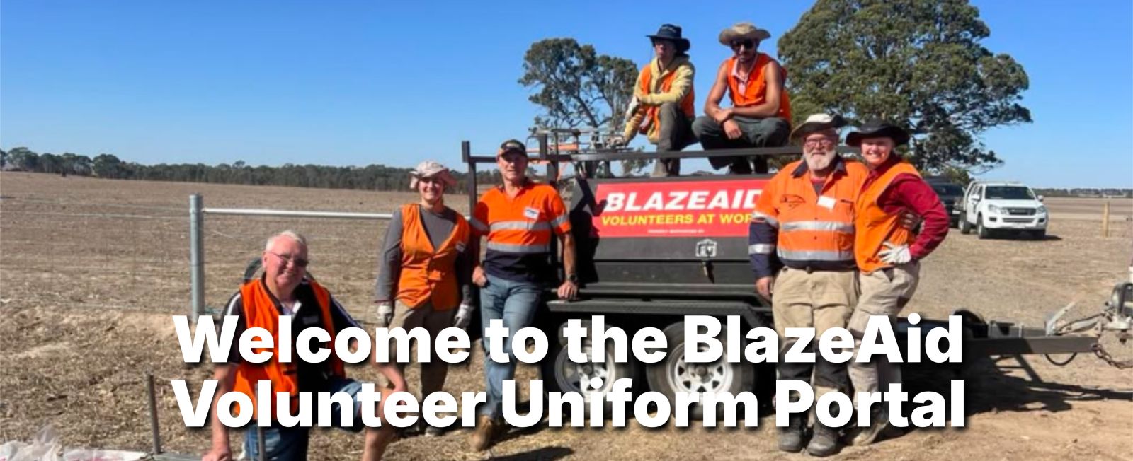 BlazeAid volunteers with their ute in a paddock